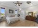 This is an inviting main bedroom featuring light walls, hard wood floors and a bathroom entrance at 1500 N Crismon Rd, Mesa, AZ 85207