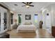 Bright main bedroom boasts recessed lighting, a ceiling fan, and access to the bathroom at 1500 N Crismon Rd, Mesa, AZ 85207