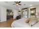 Relax in this main bedroom featuring recessed lights, wood floors, and backyard access at 1500 N Crismon Rd, Mesa, AZ 85207
