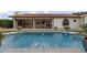 Refreshing pool with elegant fountains, complemented by a covered patio and beautiful backyard scenery at 1500 N Crismon Rd, Mesa, AZ 85207
