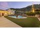 Inviting backyard pool area with waterfall feature and lush landscaping at 1500 N Crismon Rd, Mesa, AZ 85207