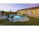 Backyard featuring a pool with stone coping and covered patio area at 1500 N Crismon Rd, Mesa, AZ 85207