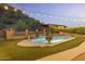 Pool with waterfall, turf lawn and ambient string lighting at 1500 N Crismon Rd, Mesa, AZ 85207