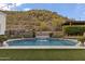 Stunning pool featuring a serene waterfall, surrounded by lush greenery and a backdrop of scenic hills at 1500 N Crismon Rd, Mesa, AZ 85207