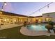 Backyard pool with turf surround, patio, and stylish outdoor lighting at 1500 N Crismon Rd, Mesa, AZ 85207