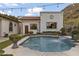Backyard with a pool featuring beautiful waterfall features surrounded by lush landscaping and lighting at 1500 N Crismon Rd, Mesa, AZ 85207