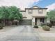 Inviting two-story home with a spacious front yard, large tree and attached garage at 16810 W Portland St, Goodyear, AZ 85338
