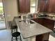 Kitchen island featuring granite countertops and seating at 16810 W Portland St, Goodyear, AZ 85338
