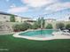 Beautiful backyard pool with artificial grass and a lounge chair perfect for relaxing at 16810 W Portland St, Goodyear, AZ 85338