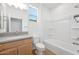 Bright bathroom features a modern vanity, tub, and window providing natural light at 18141 W Hiddenview Dr, Goodyear, AZ 85338