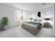 Serene bedroom with neutral tones, large window, and contemporary decor at 18141 W Hiddenview Dr, Goodyear, AZ 85338
