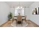 Elegant dining room with modern chandelier, seating for four, and stylish decor at 18141 W Hiddenview Dr, Goodyear, AZ 85338
