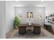 Bright home office with a large desk, comfortable seating, and stylish shelving at 18141 W Hiddenview Dr, Goodyear, AZ 85338