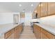 Spacious kitchen with stainless steel appliances, light countertops, and tile backsplash at 18141 W Hiddenview Dr, Goodyear, AZ 85338