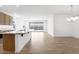Open kitchen with an island and wood floors at 18141 W Hiddenview Dr, Goodyear, AZ 85338