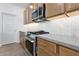 Close-up of kitchen features including the stainless steel oven and tiled backsplash at 18141 W Hiddenview Dr, Goodyear, AZ 85338