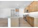 Spacious kitchen with stainless steel appliances, light countertops, and wood-look tile flooring at 18141 W Hiddenview Dr, Goodyear, AZ 85338