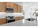 Close-up of kitchen features including the stainless steel appliances, faucet and light countertops at 18141 W Hiddenview Dr, Goodyear, AZ 85338