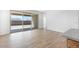 Bright living room featuring sliding glass doors to the backyard and wood-look tile flooring at 18141 W Hiddenview Dr, Goodyear, AZ 85338