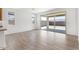 Bright living room featuring sliding glass doors to the backyard and wood-look tile flooring at 18141 W Hiddenview Dr, Goodyear, AZ 85338