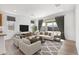Inviting living room with plush seating, modern decor, and sliding glass doors to the outdoors at 18141 W Hiddenview Dr, Goodyear, AZ 85338