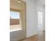 An open patio with sliding glass doors leads to an unfinished backyard area at 18141 W Hiddenview Dr, Goodyear, AZ 85338