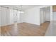 Empty Room with wood floors, lighting fixture and frosted slider at 18141 W Hiddenview Dr, Goodyear, AZ 85338