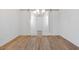 Empty Room with wood floors and lighting fixture at 18141 W Hiddenview Dr, Goodyear, AZ 85338