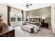 Comfortable bedroom with neutral tones, a decorative wall, and large windows, creating a relaxing atmosphere at 18848 N Barano Dr, Maricopa, AZ 85138