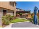 Exterior shot of a home's backyard with putting green, patio, and lush landscaping at 1931 E Lantana Dr, Chandler, AZ 85286