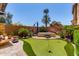 Beautifully landscaped backyard with putting green, hot tub, and lush greenery at 1931 E Lantana Dr, Chandler, AZ 85286