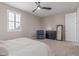 A bedroom featuring a ceiling fan, a cozy chair, and a comfortable bed, complemented by neutral walls at 1931 E Lantana Dr, Chandler, AZ 85286