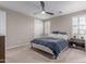 Bedroom featuring ceiling fan, window with shutters, and wood nightstand at 1931 E Lantana Dr, Chandler, AZ 85286