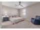 Bedroom featuring a cozy armchair, ceiling fan, and window with shutters at 1931 E Lantana Dr, Chandler, AZ 85286