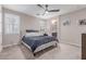Bedroom with a cozy bed, ceiling fan, and a window providing natural light at 1931 E Lantana Dr, Chandler, AZ 85286