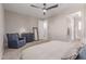A bedroom featuring carpet flooring, neutral walls, and a comfortable bed and a blue armchair at 1931 E Lantana Dr, Chandler, AZ 85286