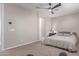 A bedroom with neutral walls, carpet flooring, a ceiling fan, and a comfortable bed with pillows at 1931 E Lantana Dr, Chandler, AZ 85286