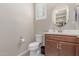 A well-lit half bathroom features a vanity, mirror, tile floor, toilet, and window at 1931 E Lantana Dr, Chandler, AZ 85286