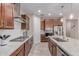 A kitchen featuring a large granite island, stainless steel appliances, and dark wood cabinets at 1931 E Lantana Dr, Chandler, AZ 85286
