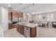 A kitchen and dining area with dark wood cabinets, stainless steel appliances, and a granite countertop island at 1931 E Lantana Dr, Chandler, AZ 85286
