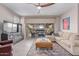 Comfortable living room featuring large windows, tile flooring, and a ceiling fan at 1931 E Lantana Dr, Chandler, AZ 85286