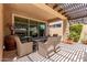 Covered patio with dining table set, tile flooring, and a beautiful backyard view at 1931 E Lantana Dr, Chandler, AZ 85286