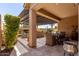 Relaxing outdoor space with a covered patio, outdoor dining, and a comfortable seating area with fireplace at 1931 E Lantana Dr, Chandler, AZ 85286