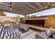 Comfortable covered patio seating around a gas fireplace with grill and outdoor fan for added relaxation at 1931 E Lantana Dr, Chandler, AZ 85286