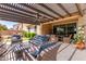 An inviting outdoor patio featuring comfortable seating, dining area, and beautiful backyard views at 1931 E Lantana Dr, Chandler, AZ 85286