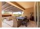 Outdoor patio with seating and dining areas with outdoor kitchen and putting green beyond at 1931 E Lantana Dr, Chandler, AZ 85286