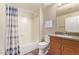 This well-lit bathroom includes a shower/tub, a toilet, and a vanity with a mirror and towel rack at 19700 N 76Th St # 2101, Scottsdale, AZ 85255