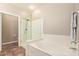 Bathroom showcasing glass enclosed shower, soaking tub, and tile floor at 19700 N 76Th St # 2101, Scottsdale, AZ 85255