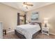 This cozy bedroom offers a comfortable bed, soft carpet, and a ceiling fan for added comfort at 19700 N 76Th St # 2101, Scottsdale, AZ 85255