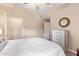 This bright bedroom features a white bed, a chest of drawers, and a door, offering both comfort and functionality at 19700 N 76Th St # 2101, Scottsdale, AZ 85255